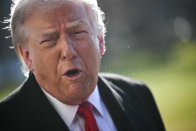 US President Donald Trump speaks to the press on his way to board Marine One as he departs from the South Lawn of the White House in Washington, DC, on January 13, 2026. Trump is travelling to Detroit, Michigan to speak to The Detroit Economic Club and visit a Ford production plant. (Photo by Brendan SMIALOWSKI / AFP)