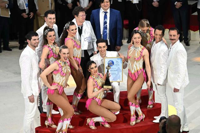 Argentine and American acrobats, members of the 'Flying Tabares' group, pose with their Gold trophy at the Capital Grand Circus during the awarding ceremony of the 16th Budapest International Circus Festival in Budapest, Hungary, on January 12, 2026. This  festival is the second-largest professional circus arts event globally, ranking just behind the International Circus Festival of Monte-Carlo. (Photo by Attila KISBENEDEK / AFP)