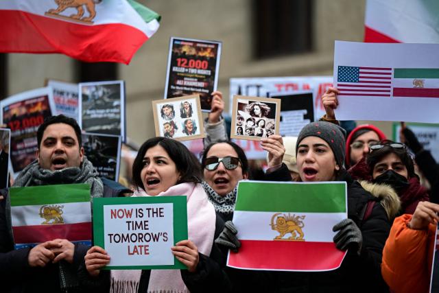 Anti-Iranian regime protesters chant slogans and hold placards during a rally outside the US Consulate in Milan on January 13, 2026. (Photo by Piero CRUCIATTI / AFP)