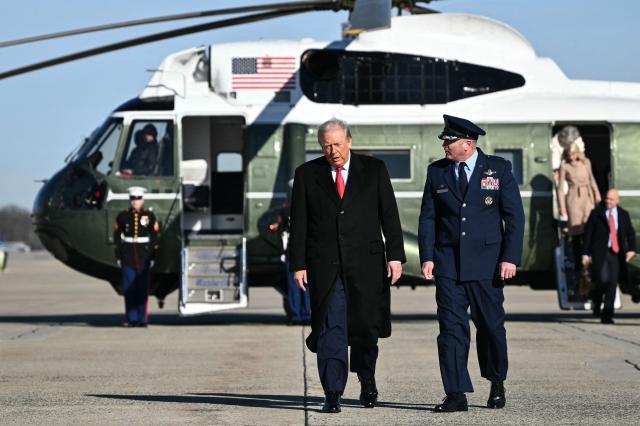 US President Donald Trump walks from Marine One to board Air Force One at Joint Base Andrews, Maryland on January 13, 2026, as he travels to Detroit, Michigan. (Photo by Mandel NGAN / AFP)
