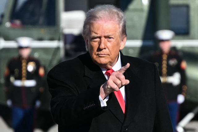 US President Donald Trump gestures as he walks to board Air Force One at Joint Base Andrews, Maryland on January 13, 2026, as he travels to Detroit, Michigan. (Photo by Mandel NGAN / AFP)