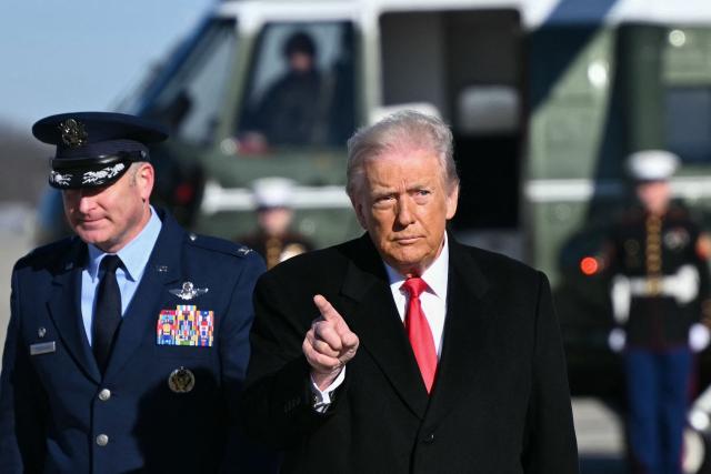 US President Donald Trump gestures as he walks to board Air Force One at Joint Base Andrews, Maryland on January 13, 2026, as he travels to Detroit, Michigan. (Photo by Mandel NGAN / AFP)