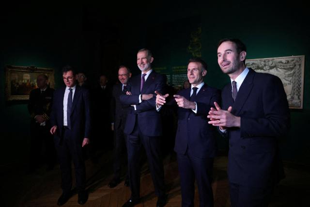 French President Emmanuel Macron (2nd R) and King Felipe VI of Spain (3rd R) visit the exhibition "The Grand Dauphin (1661-1711), son of a King, father of a King, and never King" at the Chateau de Versailles in Versailles, near Paris, on January 13, 2026. (Photo by Gonzalo Fuentes / POOL / AFP)