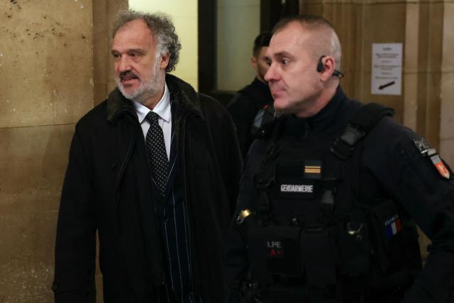 French lawyer of President of Rassemblement National parliamentary group Marine Le Pen, Rodolphe Bosselut (L) arrives at the courtroom on the first day of a hearing in her appeal trial on suspicion of embezzlement of European public funds, at Paris courthouse, on January 13, 2026. The appeal comes after a court last year barred the President of the RN parliamentary group Marine Le Pen from running for office for five years over a European Parliament fake-jobs scam involving her and other officials from her National Rally party. The hearing is expected to run until February 11, 2026, with a decision expected this summer. Twelve of the accused, as well as the far-right party itself, have appealed against the verdict while another 12 people -- including one of Le Pen's sisters -- have decided to accept their convictions without appealing. (Photo by Thomas SAMSON / AFP)