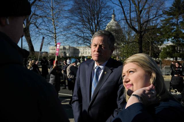 (L/R) US Senator Steve Daines, Republican from Montana, and US Representative Kat Cammack, Republican from Florida, gather outside the US Supreme Court as justices hear arguments in challenges to state bans on transgender girls and women in sports, in Washington, DC, on January 13, 2026. The US Supreme Court on January 13 wades into the hot-button issue of transgender athletes in girls' and women's sports. The conservative-dominated court is to hear challenges to state laws in Idaho and West Virginia banning transgender athletes from female competition. More than two dozen US states have passed laws in recent years barring athletes who were assigned as male at birth from taking part in girls' or women's sports. (Photo by Oliver Contreras / AFP)