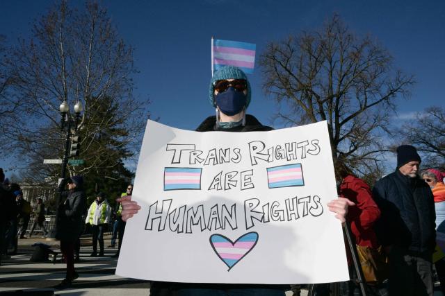 LGBTQ+ rights advocates rally outside the US Supreme Court as justices hear arguments in challenges to state bans on transgender girls and women in sports, in Washington, DC, on January 13, 2026. The US Supreme Court on January 13 wades into the hot-button issue of transgender athletes in girls' and women's sports. The conservative-dominated court is to hear challenges to state laws in Idaho and West Virginia banning transgender athletes from female competition. More than two dozen US states have passed laws in recent years barring athletes who were assigned as male at birth from taking part in girls' or women's sports. (Photo by Oliver Contreras / AFP)