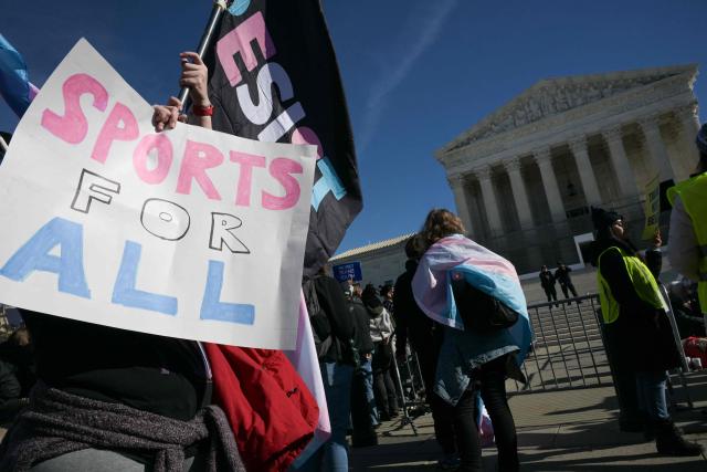 LGBTQ+ rights advocates rally outside the US Supreme Court as justices hear arguments in challenges to state bans on transgender athletes in women's sports on January 13, 2026, in Washington, DC. The US Supreme Court on January 13 wades into the hot-button issue of transgender athletes in girls' and women's sports. The conservative-dominated court is to hear challenges to state laws in Idaho and West Virginia banning transgender athletes from female competition. More than two dozen US states have passed laws in recent years barring athletes who were assigned as male at birth from taking part in girls' or women's sports. (Photo by Oliver Contreras / AFP)