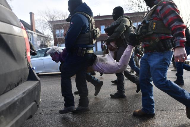 ICE and other federal officers detain a person during protests in Minneapolis, Minnesota, on January 13, 2026. Hundreds more federal agents were heading to Minneapolis, the US homeland security chief said on January 11, brushing aside demands by the Midwestern city's Democratic leaders to leave after an immigration officer fatally shot a woman protester. In multiple TV interviews, US Homeland Secretary Kristi Noem defended the actions of the officer who shot and killed 37-year-old Renee Nicole Good, whose death has sparked renewed protests nationwide against President Donald Trump's immigration crackdown. (Photo by Octavio JONES / AFP)