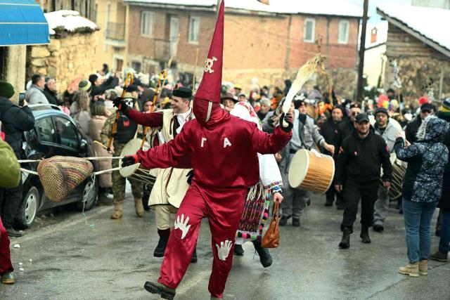 Revellers take part in a carnival procession through the village of Vevcani, south-western Macedonia, on January 13, 2026. The carnival, which is over 1400 years old, is held every year on the eve of the feast of Saint Basil, which also marks the beginning of the New Year according to the Julian calendar and observed by the Macedonian Orthodox Church. (Photo by Robert ATANASOVSKI / AFP)