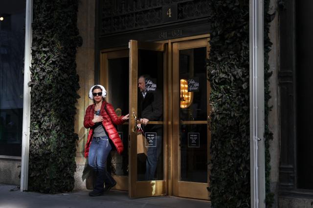 People exit the Saks Fifth Avenue department store in New York on January 13, 2026. US consumer inflation was steady in December as analysts expected, government data showed on January 13, 2026, capping a year in which affordability worries flared while President Donald Trump's tariffs weighed on the economy. The consumer price index (CPI), a key inflation gauge, rose 2.7 percent last month from a year ago, the same rate as in November, said the Department of Labor. (Photo by ANGELA WEISS / AFP)