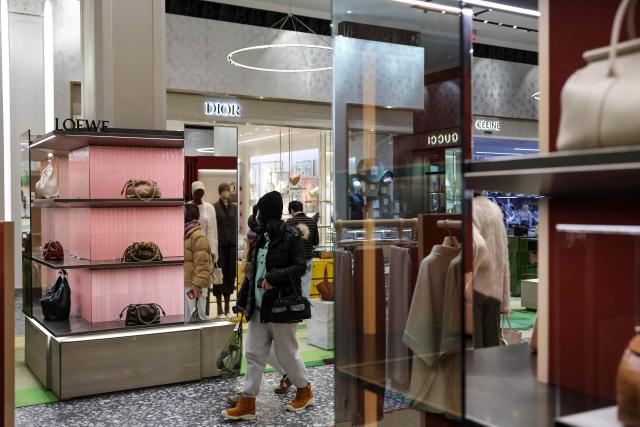 People shop at the Saks Fifth Avenue department store in New York on January 13, 2026. US consumer inflation was steady in December as analysts expected, government data showed on January 13, 2026, capping a year in which affordability worries flared while President Donald Trump's tariffs weighed on the economy. The consumer price index (CPI), a key inflation gauge, rose 2.7 percent last month from a year ago, the same rate as in November, said the Department of Labor. (Photo by ANGELA WEISS / AFP)