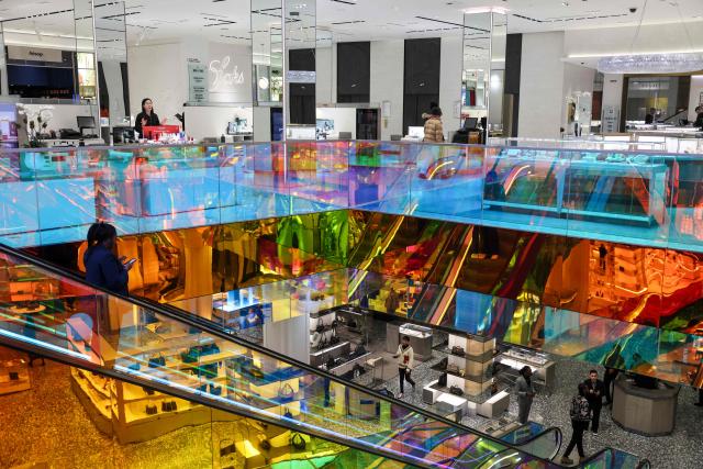 People ride an escalator at the Saks Fifth Avenue department store in New York on January 13, 2026. US consumer inflation was steady in December as analysts expected, government data showed on January 13, 2026, capping a year in which affordability worries flared while President Donald Trump's tariffs weighed on the economy. The consumer price index (CPI), a key inflation gauge, rose 2.7 percent last month from a year ago, the same rate as in November, said the Department of Labor. (Photo by ANGELA WEISS / AFP)