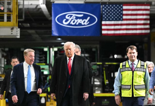 US President Donald Trump speaks with Ford executive chairman Bill Ford (L) and Ford CEO Jim Farley (R) as he tours Ford Motor Company's River Rouge complex in Dearborn, Michigan, on January 13, 2026. (Photo by Mandel NGAN / AFP)
