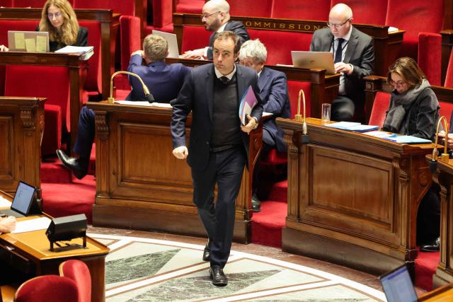 France's Prime Minister Sebastien Lecornu walks during the debate on the budget bill for the year 2026 at The National Assembly, France's lower house parliament, in Paris on January 13, 2026. (Photo by Ludovic MARIN / AFP)