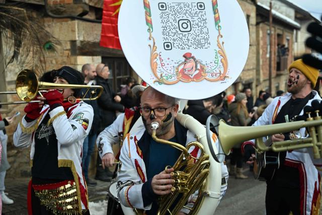 Revellers play musical instruments as they take part in a carnival procession through the village of Vevcani, south-western Macedonia, on January 13, 2026. The carnival, which is over 1400 years old, is held every year on the eve of the feast of Saint Basil, which also marks the beginning of the New Year according to the Julian calendar and observed by the Macedonian Orthodox Church. (Photo by Robert ATANASOVSKI / AFP)