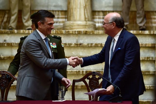 Bolivia's President Rodrigo Paz (R) greets Inter-American Development Bank (IDB) President Ilan Goldfajn before a press conference at the Palacio Quemado government palace in La Paz on January 13, 2026. (Photo by Jorge BERNAL / AFP)