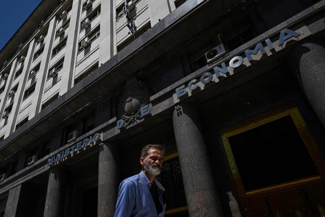 (FILES) A man walks past Argentina's Ministry of Economy in Buenos Aires on February 13, 2025. Inflation in Argentina rose slightly in December after six consecutive months of increases but ended 2025 at 31.5% compared to December of the previous year, its lowest level in eight years, the national statistics institute (Indec) reported on January 13, 2026. (Photo by LUIS ROBAYO / AFP)