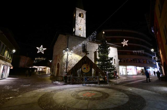 People stroll in the main street of Bormio which will host all the alpine men's skiing events as part of the Milano Cortina 2026 Olympics, on January 13, 2026. (Photo by Stefano RELLANDINI / AFP)