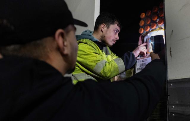 Farmers control the loading of a truck at a roundabout in Quimper, western of France on January 13, 2026 during a farmers' blockade to protest against the government's mandatory culling protocol for cattle herds affected by lumpy skin disease (dermatose nodulaire contagieuse) and the EU-Mercosur trade deal. (Photo by Fred TANNEAU / AFP)