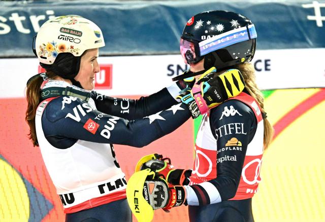 Winner US' Mikaela Shiffrin (R) celebrates with US' Paula Moltzan after the women's slalom race of the FIS Alpine Ski World Cup in Flachau, Austria, on January 13, 2026. (Photo by BARBARA GINDL / APA / AFP) / Austria OUT