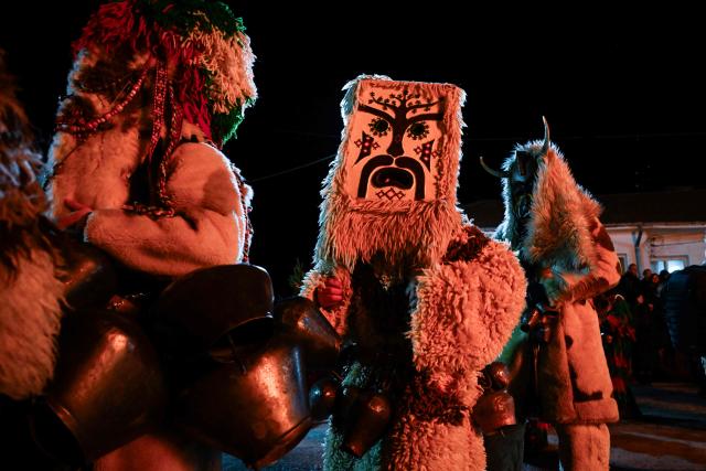 Bulgarian dancers wearing costumes perform a ritual dance around a bonfire during the Kukeri Carnival in the village of Sadovik, western Bulgaria, on January 13, 2026. The kukeri rituals culminate in dances on the evening of January 13 and the morning of the January 14, when the men put on masks and go around the villages, dancing with numerous bells to make noise and drive away evil spirits and send off the old year and to mark the beginning of Spring. (Photo by Nikolay DOYCHINOV / AFP)
