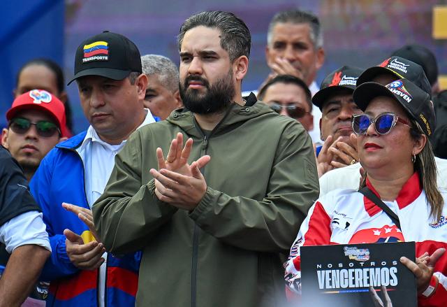 Deputy Nicolas Maduro Guerra, son of ousted President Nicolas Maduro, attends a march in Caracas on January 13, 2026, to demand the release of Maduro and his wife Cilia Flores, snatched and taken to New York on January 3 to face trial on drug and weapons charges. Venezuela is working to identify the ‘human remains’ found after the United States attack that led to the fall of Nicolas Maduro and left around one hundred dead, Interior Minister Diosdado Cabello said on January 13, 2026. (Photo by Juan BARRETO / AFP)