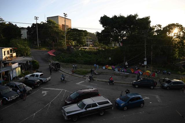 Relatives of inmates camp while waiting for news about the release of prisoners outside El Rodeo I prison in Guatire, Miranda State, some 30 kilometers east of Caracas on January 13, 2026. Venezuela said on January 12, it had freed dozens more political prisoners as rights groups questioned the numbers and family members clamored for speedier releases after the US military ouster of long-term autocrat Nicolas Maduro. (Photo by Federico PARRA / AFP)