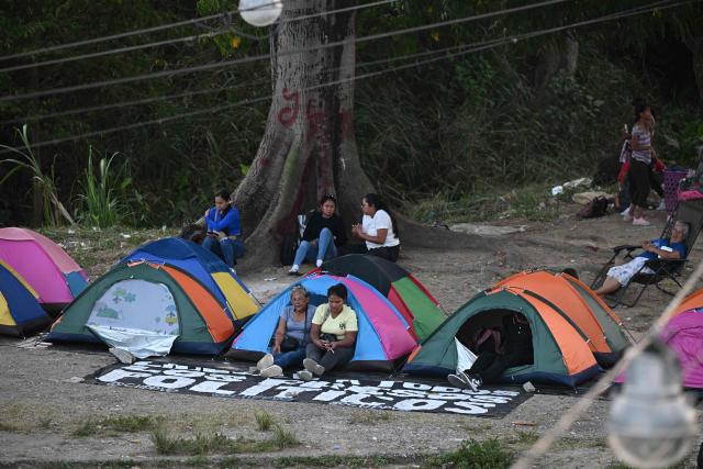 Relatives of inmates camp while waiting for news about the release of prisoners outside El Rodeo I prison in Guatire, Miranda State, some 30 kilometers east of Caracas on January 13, 2026. Venezuela said on January 12, it had freed dozens more political prisoners as rights groups questioned the numbers and family members clamored for speedier releases after the US military ouster of long-term autocrat Nicolas Maduro. (Photo by Federico PARRA / AFP)