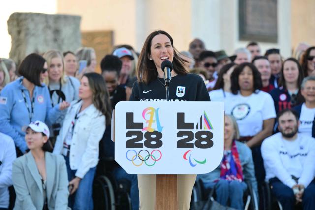 Former Olympic swimmer and Chief Athlete Officer for LA2028 Janet Evans speaks during a ceremonial lighting of the LA2028 Olympic cauldron at the Memorial Coliseum in Los Angeles on January 13, 2026, ahead of the launch of ticket registration for the 2028 Summer Olympic Games. (Photo by Frederic J. Brown / AFP)