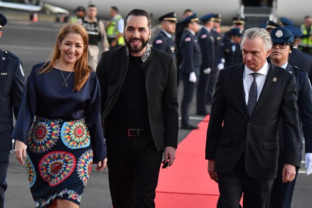 Costa Rica's Vice President Mary Munive (L) and Costa Rica's Foreign Minister Andre Tinoco (R) welcome El Salvador's President Nayib Bukele upon his arrival at Juan Santa Maria International Airport in Alajuela, Costa Rica, on January 13, 2026. (Photo by EZEQUIEL BECERRA / AFP)