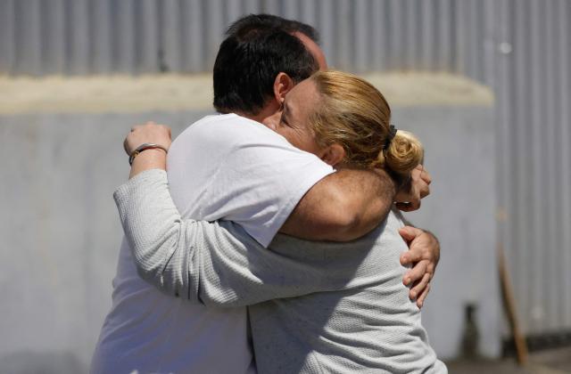 A couple comfort each other during a vigil to demand freedom for political prisoners outside Zone 7 of the Bolivarian National Police (PNB), also known as the Boleita Detention and Custody Center, in the municipality of Sucre, Caracas Metropolitan District (DMC), on January 13, 2026. Venezuela said on January 12, it had freed dozens more political prisoners as rights groups questioned the numbers and family members clamored for speedier releases after the US military ouster of long-term autocrat Nicolas Maduro. (Photo by Pedro MATTEY / AFP)