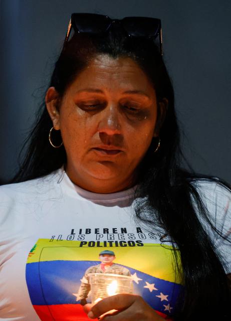A woman cries during a vigil to demand freedom for political prisoners at El Helicoide -a facility and prison owned by the Venezuelan government and used for both regular and political prisoners of the Bolivarian National Intelligence Service (SEBIN)- in Caracas on January 13, 2026. Venezuela said on January 12, it had freed dozens more political prisoners as rights groups questioned the numbers and family members clamored for speedier releases after the US military ouster of long-term autocrat Nicolas Maduro. (Photo by Pedro MATTEY / AFP)