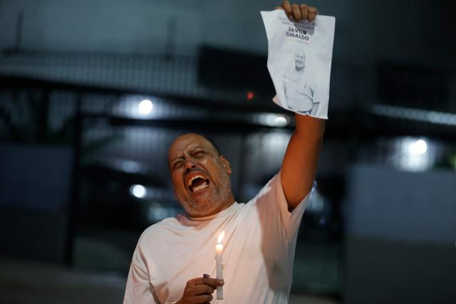 A man shouts slogans during a vigil to demand freedom for political prisoners at El Helicoide -a facility and prison owned by the Venezuelan government and used for both regular and political prisoners of the Bolivarian National Intelligence Service (SEBIN)- in Caracas on January 13, 2026. Venezuela said on January 12, it had freed dozens more political prisoners as rights groups questioned the numbers and family members clamored for speedier releases after the US military ouster of long-term autocrat Nicolas Maduro. (Photo by Pedro MATTEY / AFP)