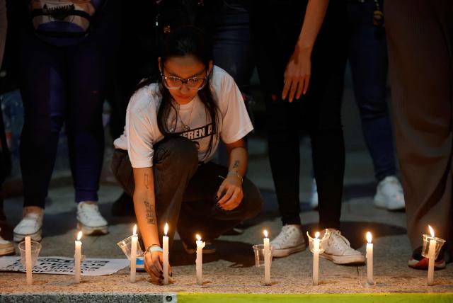A woman lit a candle during a vigil to demand freedom for political prisoners at El Helicoide -a facility and prison owned by the Venezuelan government and used for both regular and political prisoners of the Bolivarian National Intelligence Service (SEBIN)- in Caracas on January 13, 2026. Venezuela said on January 12, it had freed dozens more political prisoners as rights groups questioned the numbers and family members clamored for speedier releases after the US military ouster of long-term autocrat Nicolas Maduro. (Photo by Pedro MATTEY / AFP)