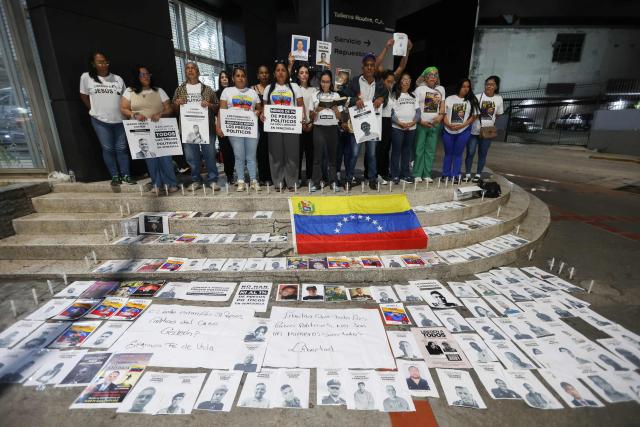 People attend a vigil to demand freedom for political prisoners at El Helicoide -a facility and prison owned by the Venezuelan government and used for both regular and political prisoners of the Bolivarian National Intelligence Service (SEBIN)- in Caracas on January 13, 2026. Venezuela said on January 12, it had freed dozens more political prisoners as rights groups questioned the numbers and family members clamored for speedier releases after the US military ouster of long-term autocrat Nicolas Maduro. (Photo by Pedro MATTEY / AFP)