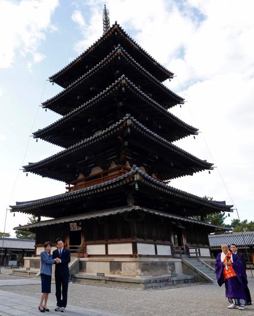 Japan's Prime Minister Sanae Takaichi (L) and South Korea's President Lee Jae Myung (2nd L) pose in front of the Five-storied Pagoda at the Horyu-ji Temple in Ikaruga, Nara prefecture on January 14, 2026. (Photo by Franck ROBICHON / POOL / AFP)