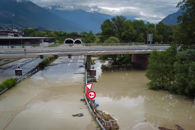 (FILES) An aerial picture taken on June 30, 2024 shows the A9 motorway A9 partially flooded near Sierre, western Switzerland. The Copernicus Institute releases its report on world temperatures on January 14, 2026. (Photo by Boris HEGER / AFP)