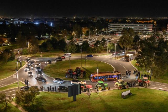 Farmers of the agricultural union Coordination Rurale (CR) park their tractors outside Toulouse airport in Toulouse, southwestern France on January 14, 2026 in protest against the government's mandatory culling protocol for cattle herds affected by lumpy skin disease (dermatose nodulaire contagieuse) and the EU-Mercosur trade deal. (Photo by Ed JONES / AFP)