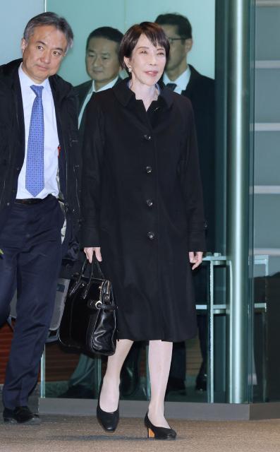Japan's Prime Minister Sanae Takaichi (C) enters the Prime Minister's office in Tokyo on January 14, 2026 after concluding diplomatic meetings with South Korea's President Lee Jae Myung in Nara Prefecture. (Photo by JIJI Press / AFP) / Japan OUT