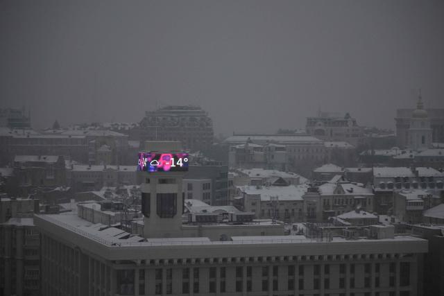 This photograph shows a big screen on a building displaying a temperature of -14 degrees Celsius in Kyiv on January 14, 2026, amid the Russian invasion of Ukraine. (Photo by Sergei GAPON / AFP)
