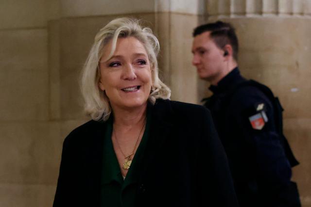 President of the parliamentary group of the French far-right Rassemblement National (RN) party, Marine Le Pen arrives for a hearing in her appeal trial on suspicion of embezzlement of European public funds, at Paris courthouse, on January 14, 2026. The appeal comes after a court last year barred the President of the RN parliamentary group Marine Le Pen from running for office for five years over a European Parliament fake-jobs scam involving her and other officials from her National Rally party. The hearing is expected to run until February 11, 2026, with a decision expected this summer. Twelve of the accused, as well as the far-right party itself, have appealed against the verdict while another 12 people -- including one of Le Pen's sisters -- have decided to accept their convictions without appealing. (Photo by Thomas SAMSON / AFP)