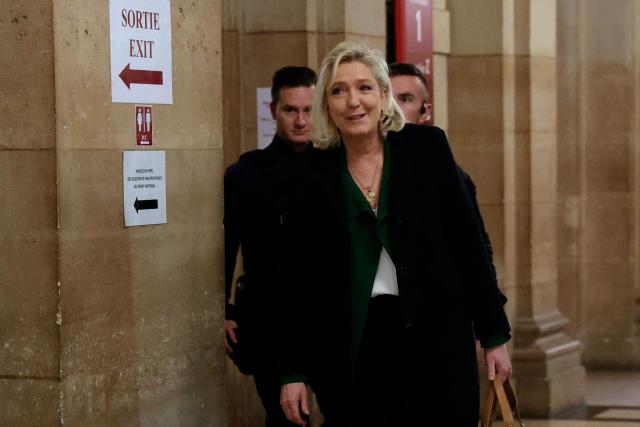 President of the parliamentary group of the French far-right Rassemblement National (RN) party, Marine Le Pen arrives for a hearing in her appeal trial on suspicion of embezzlement of European public funds, at Paris courthouse, on January 14, 2026. The appeal comes after a court last year barred the President of the RN parliamentary group Marine Le Pen from running for office for five years over a European Parliament fake-jobs scam involving her and other officials from her National Rally party. The hearing is expected to run until February 11, 2026, with a decision expected this summer. Twelve of the accused, as well as the far-right party itself, have appealed against the verdict while another 12 people -- including one of Le Pen's sisters -- have decided to accept their convictions without appealing. (Photo by Thomas SAMSON / AFP)