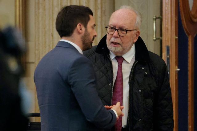 Rassemblement National's MP Julien Odoul (L) speaks with Wallerand de Saint-Just, member of French far-right party Rassemblement National (RN), as they arrive for a hearing in their appeal trial on suspicion of embezzlement of European public funds, at Paris courthouse, on January 14, 2026. The appeal comes after a court last year barred the President of the RN parliamentary group Marine Le Pen from running for office for five years over a European Parliament fake-jobs scam involving her and other officials from her National Rally party. The hearing is expected to run until February 11, 2026, with a decision expected this summer. Twelve of the accused, as well as the far-right party itself, have appealed against the verdict while another 12 people -- including one of Le Pen's sisters -- have decided to accept their convictions without appealing. (Photo by Thomas SAMSON / AFP)