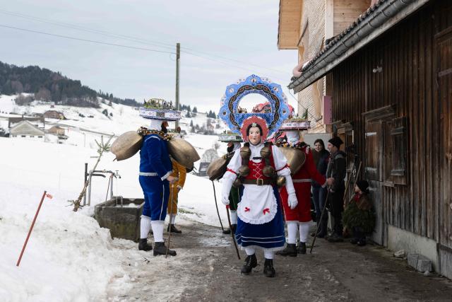 'Schoene' (Beautiful) costumed members of the yodel group 'Spitzli Schueppel' take part in the traditional 'Silvesterchlausen' (Saint Sylvester’s Day festivities) in Urnasch, eastern Switzerland, on January 13, 2026. Silvesterchlausen a traditional custom from the Swiss canton of Appenzell, features colorfully dressed figures organized in groups called 'Schuppel' who symbolically chase away the old year and welcome the new one by traveling from farmstead to farmstead to sing yodels and greet farmers. The tradition take place twice a year: on December 31 for the “New Silvester,” and again on January 13, following the old Julian calendar. (Photo by ENNIO LEANZA / AFP)