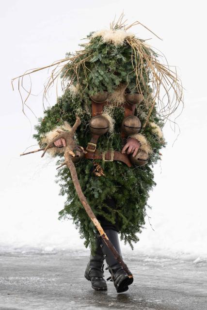 A ‘Schoe-Wueeschten’ (‘Pretty-Ugly’) costumed member of a yodeling group takes part in the traditional 'Silvesterchlausen' (Saint Sylvester’s Day festivities) in Urnasch, eastern Switzerland, on January 13, 2026. Silvesterchlausen a traditional custom from the Swiss canton of Appenzell, features colorfully dressed figures organized in groups called 'Schuppel' who symbolically chase away the old year and welcome the new one by traveling from farmstead to farmstead to sing yodels and greet farmers. The tradition take place twice a year: on December 31 for the “New Silvester,” and again on January 13, following the old Julian calendar. (Photo by ENNIO LEANZA / AFP)