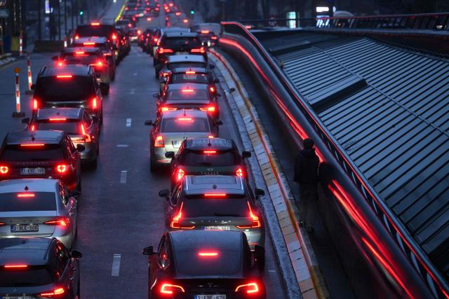 Vehicles drive in traffic in Brussels on January 14, 2026. (Photo by Nicolas TUCAT / AFP)