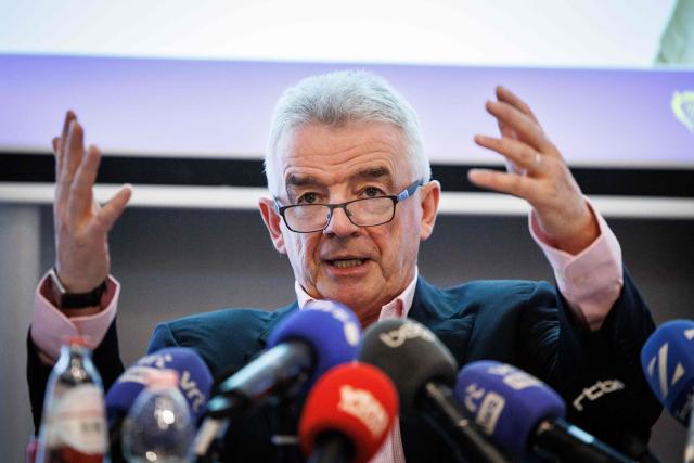 Irish budget Chief executive of lowcost airline Ryanair, Michael O'Leary gestures during a press conference regarding Belgium's "embarkation tax" in Brussels on January 14, 2026. Ryanair announced on December 9, 2025, it was to cut "1 million seats and 20 routes from its Brussels Winter 2026-2027 schedule" following the increase of the Belgian "embarkation tax" usually referred to as the "flight-ticket tax". (Photo by Simon Wohlfahrt / AFP)