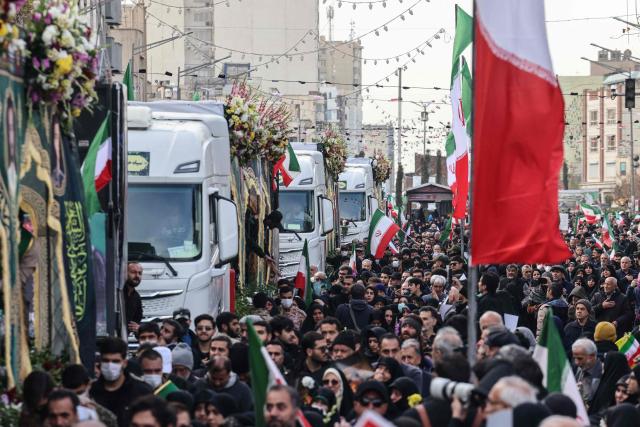 Iranians attend the funerals of security forces personnel killed in recent protests in Tehran on January 14, 2026. A funeral ceremony began in Tehran on January 14, 2026 for over 100 members of the security forces and other "martyrs" killed in the wave of protests that has rocked the Islamic republic, state television said. (Photo by ATTA KENARE / AFP)