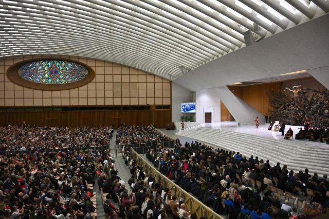 Pope Leo XIV (R) attends the weekly general audience at Paul VI Hall in the Vatican on January 14, 2026. (Photo by Andreas SOLARO / AFP)