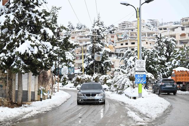 TOPSHOT - This photo taken on January 14, 2026 shows the snow covered Syrian town of Bludan, some 50 kilometres northwest of the capital Damascus. (Photo by LOUAI BESHARA / AFP)